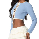 Light blue long-sleeve top with white ruffled details worn by a person